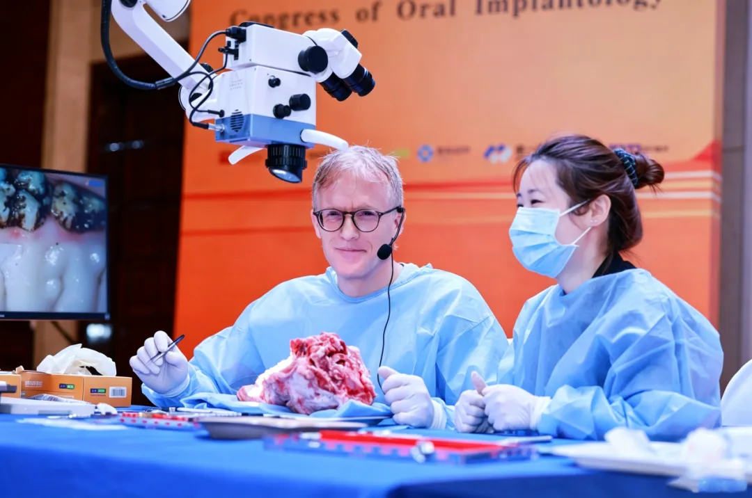 Participants using dental operating microscopes during hands-on training at the implant congress